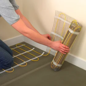 rolling out ambermat electric underfloor heating.